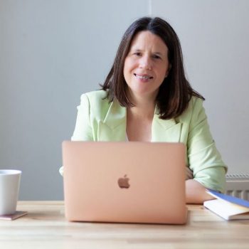 Photo of Natalie with her laptop, smiling